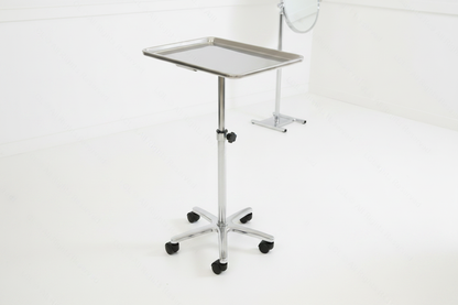Adjustable rolling steel salon tray trolley, chrome finish, side angle view in a modern salon